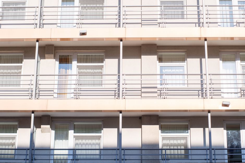A clean view of a contemporary apartment building exterior showcasing balconies and windows.