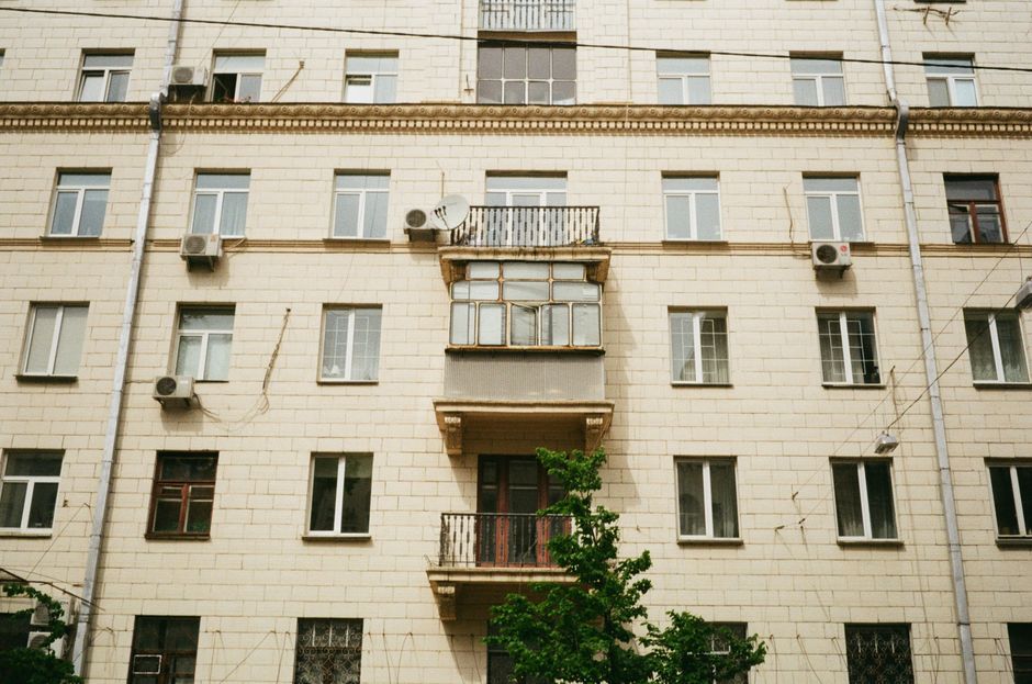 Front view of a modern apartment building in Kyiv featuring windows and balconies.